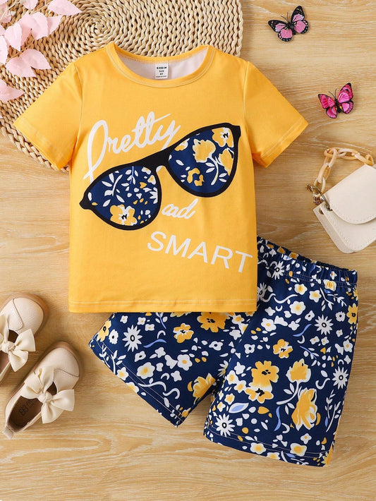 Set for young girls featuring a t-shirt with eyeglasses and letter print, paired with flower print shorts.