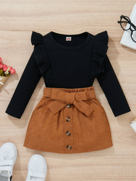 Ribbed knit top with ruffle trim and belted skirt for toddler girls.