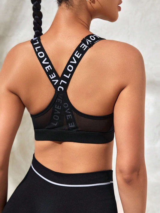 Sports bra for women with letter jacquard woven straps and mesh splicing.