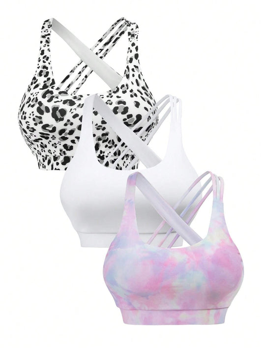 Set of three workout tops featuring tie-dye and leopard print designs, with crisscross backless sports bra styling.