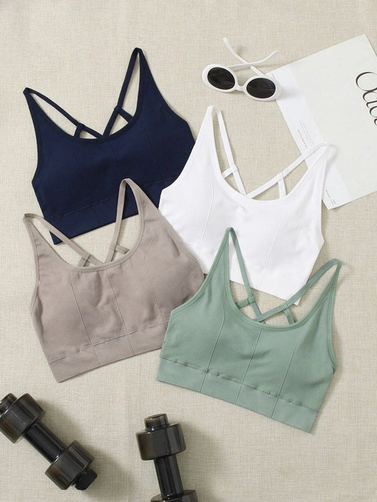 Set of four medium support seamless sports bras with crisscross design, perfect for yoga basics.