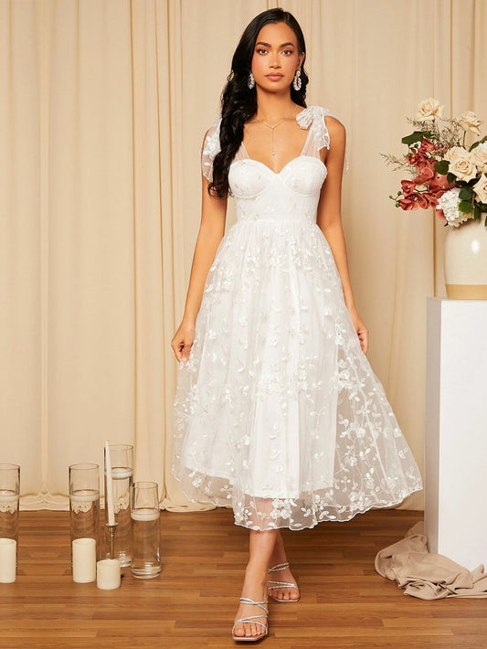 Elegant Dress with Floral Embroidered Bodice, Lace-Up Shoulder Detail, and Bow Accent.