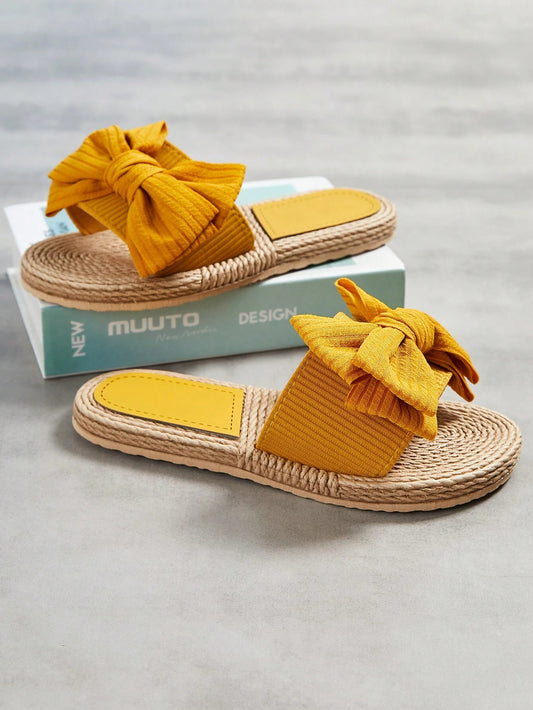 Open-toe flat sandals for women with a fashionable bow decor strap, perfect for vacation wear.